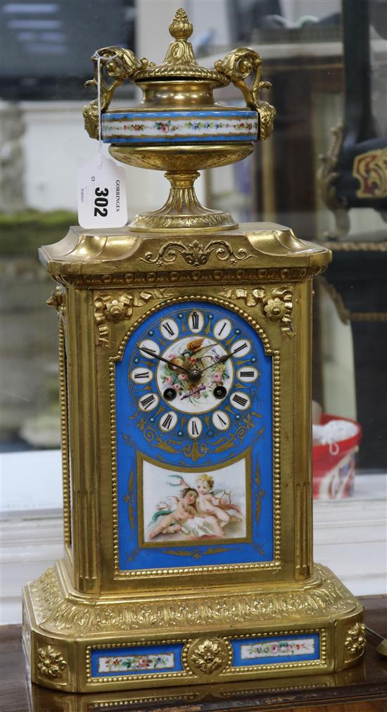 A late 19th century Louis XVI style gilt brass eight day striking mantel clock, with Sevres style inset panels, 19.75in.